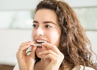 Woman placing Invislaing tray