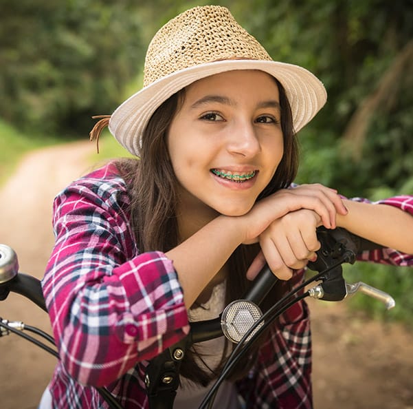 Young girl with braces smiling outdoors