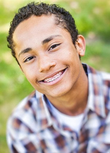 Teen boy with braces smiling