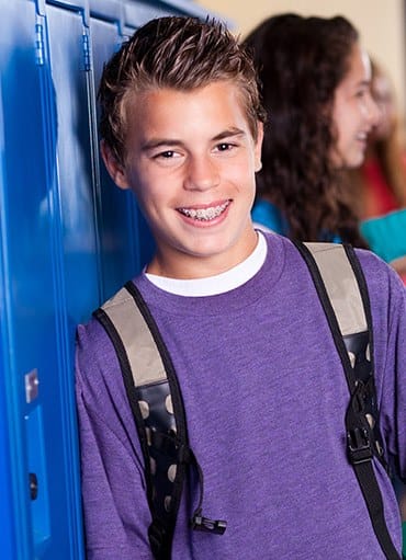 Teen boy with braces at school