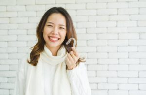 woman holding adult Invisalign 