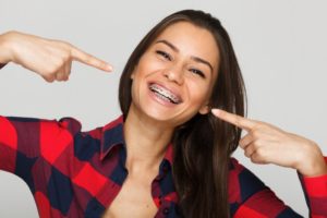 girl pointing to her braces 