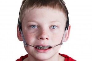 Boy wearing orthodontic headgear in Glenpool