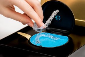 a person placing their aligners safely in their case